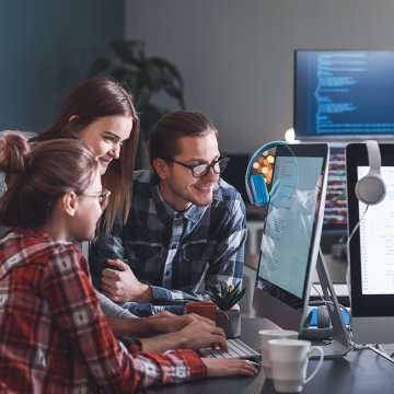 people sitting around a computer screen